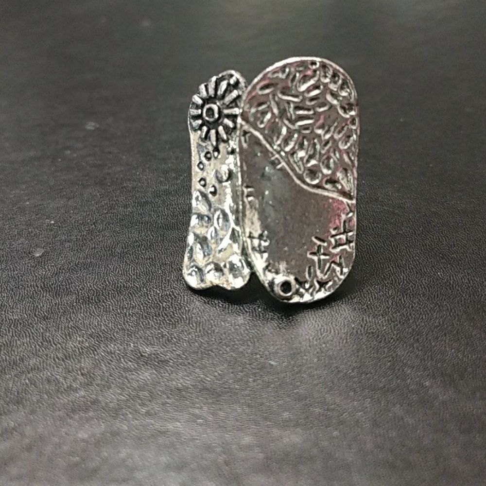 Silver tone abstract ring with textured flower